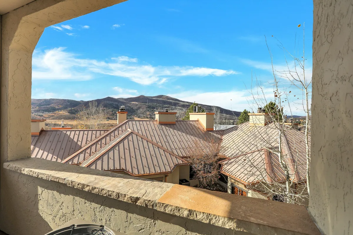 A tranquil panorama showing a mountain range, rooftops, and a clear sky—capturing the essence of Steamboat Springs' scenic environment. The view invites residents to savor sunrise moments, stargazing, or simply relaxing outdoors.